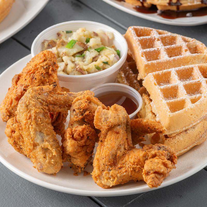 Waffles served with potato salad and warm syrup