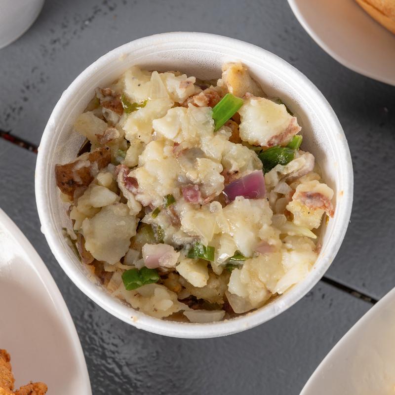 Potato salad with chopped onions and herbs