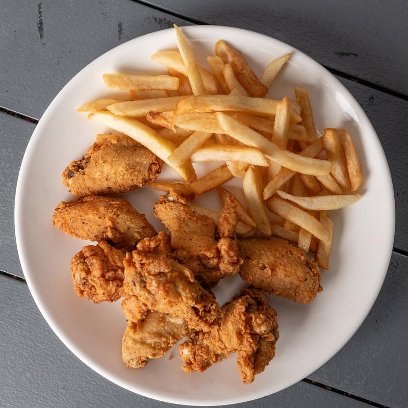 Fried chicken wings served with seasoned fries