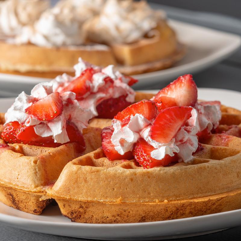 Waffle with whipped cream and strawberries