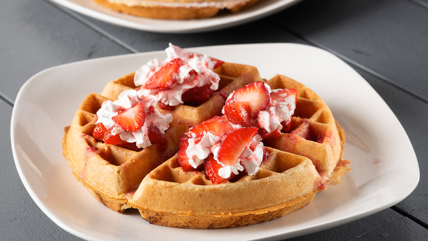 Strawberry waffle with fresh strawberries and whipped cream
