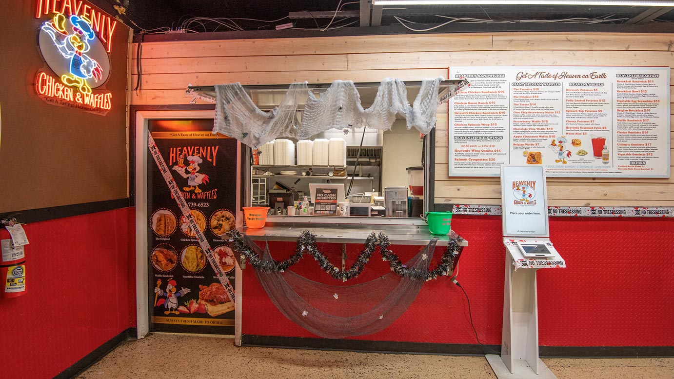 The Heavenly Chicken and Waffles order counter and menu board in Redford