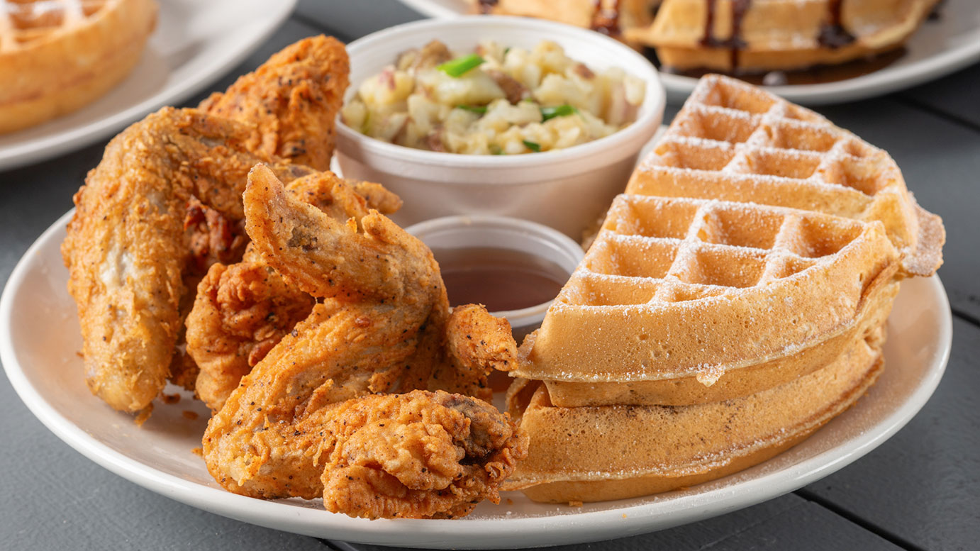 Fried whole wings served with a golden Belgian waffle and potatoes