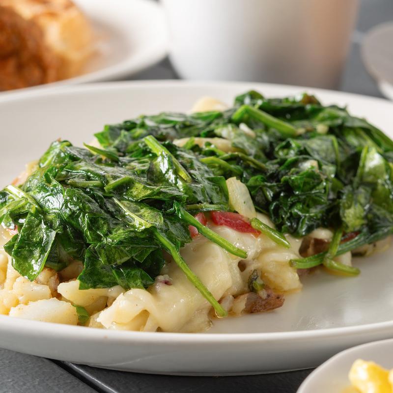 Heavenly potatoes topped with melted Swiss cheese and spinach