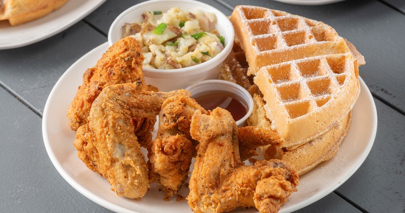 Fried chicken wings, a Belgian waffle, heavenly potatoes and syrup